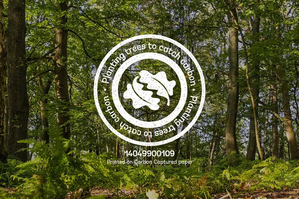 The woodland trust logo over an image of a thick forest.