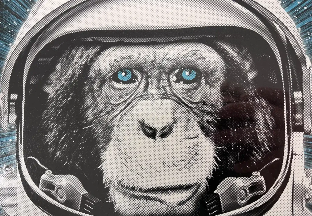 Art print on metallic paper depicting a monkey in a space suit.