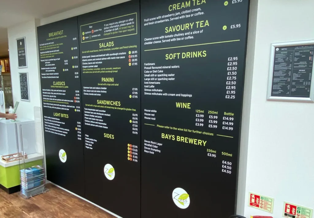 Large wall-sized menu featuring clear, bold text and organised sections, designed to display a full range of offerings in a visually striking and easily readable format.