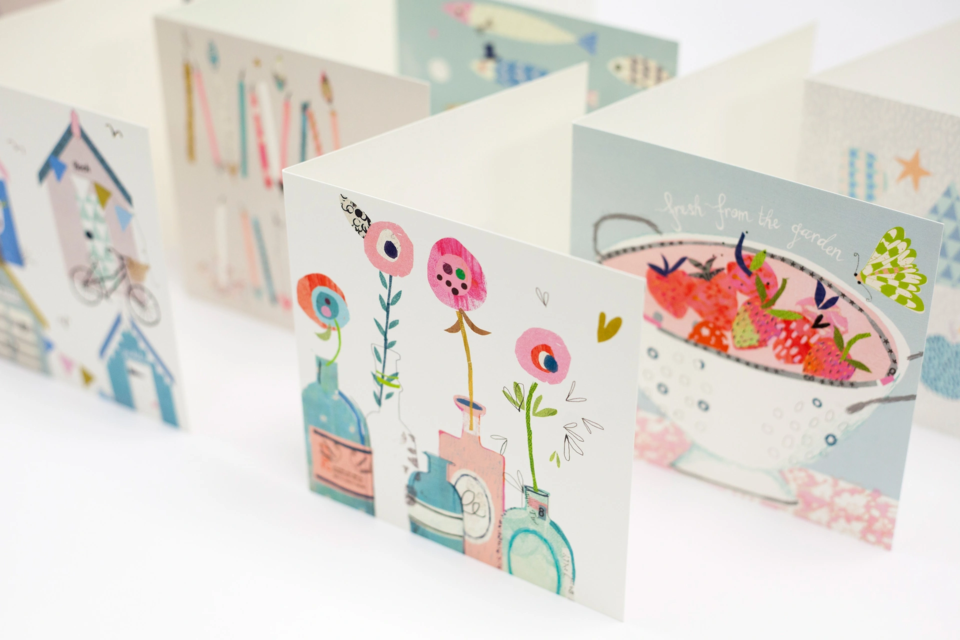 Light coloured, beautifully printed greeting cards with various custom designs.