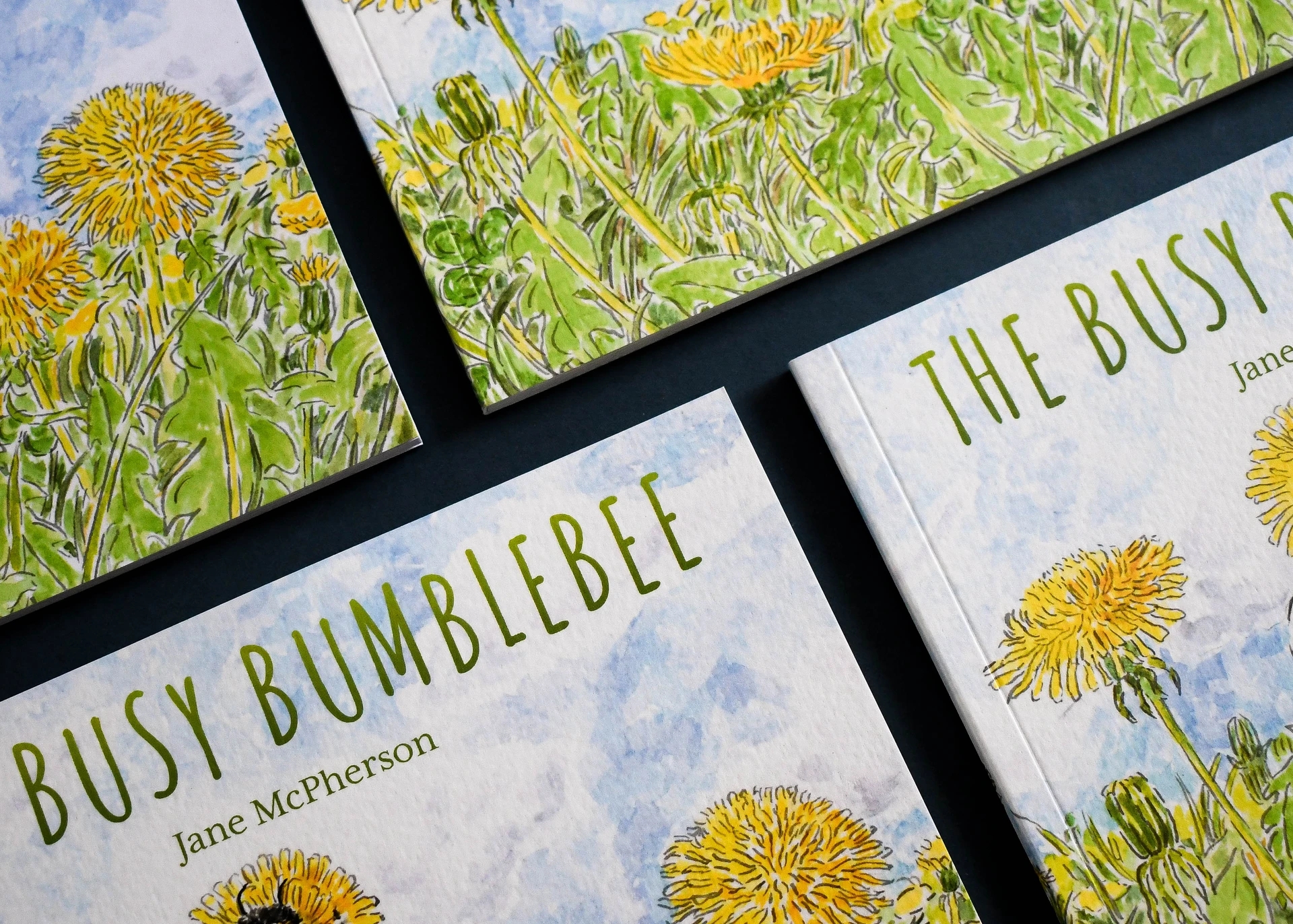 Three copies of The Busy Bumblebee by Jane McPherson overlapping, watercolour covers on textured stock.