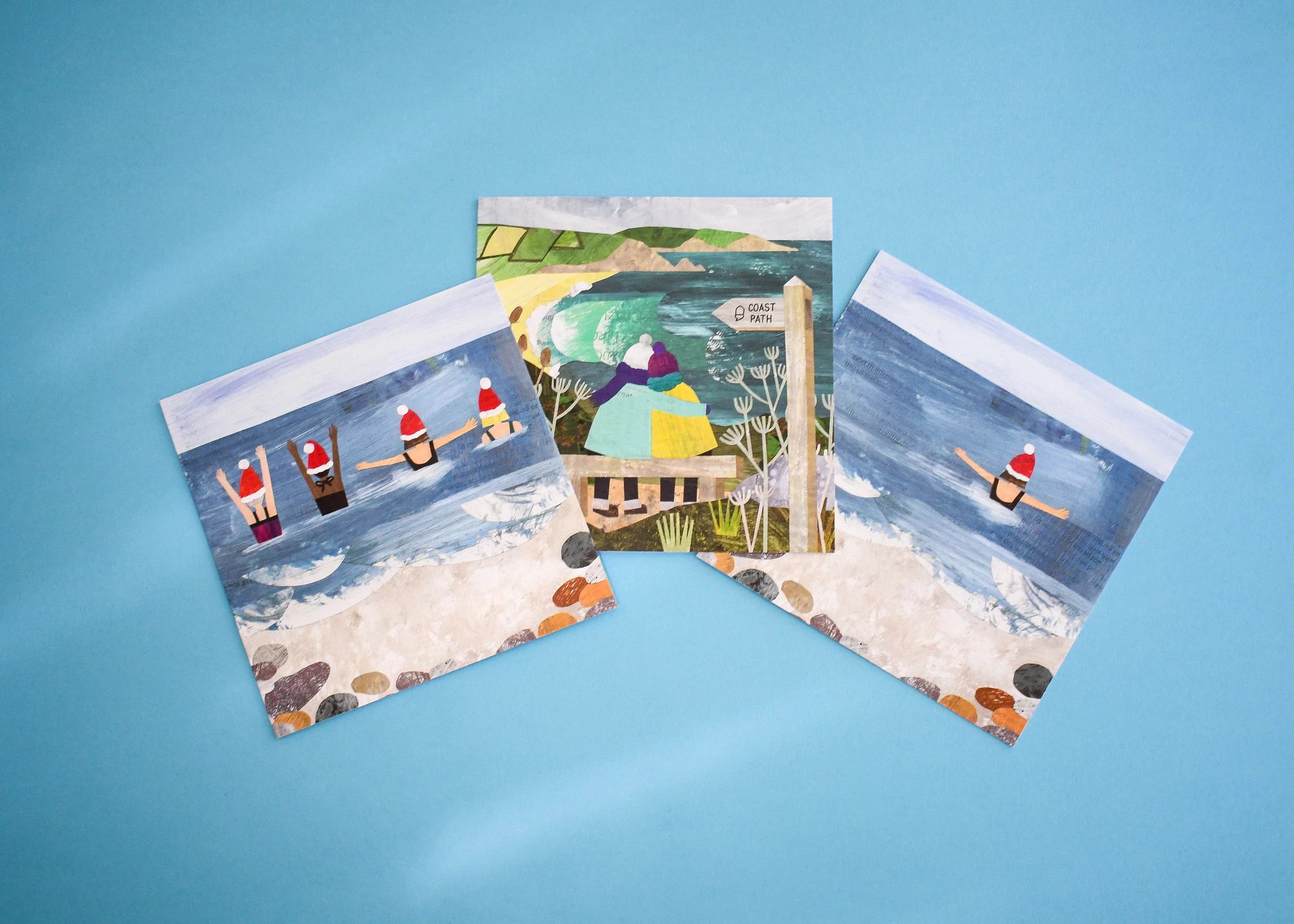 Three square cards from the same coastal set, fanned out to show each design.