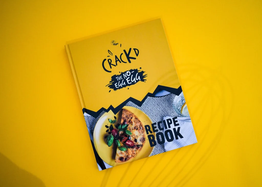 The Crackd recipe book cover, a yellow hardback with full colour food photography.