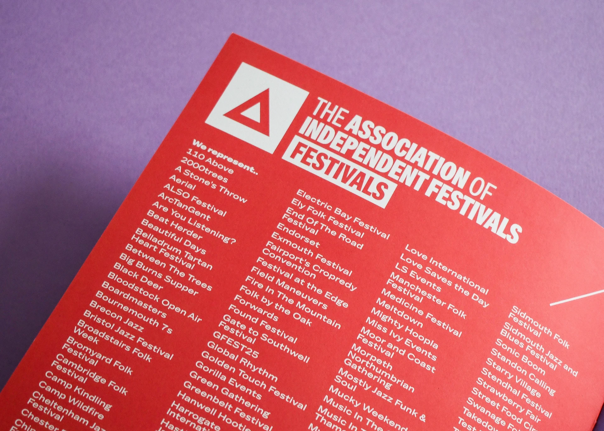Digitally printed red festival poster featuring Association of Independent Festivals list with sharp typography and vibrant colour