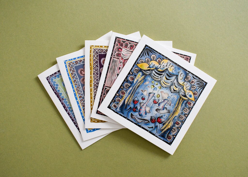 Fanned arrangement of digitally printed greeting cards displaying colourful illustrated designs and consistent high quality print finish