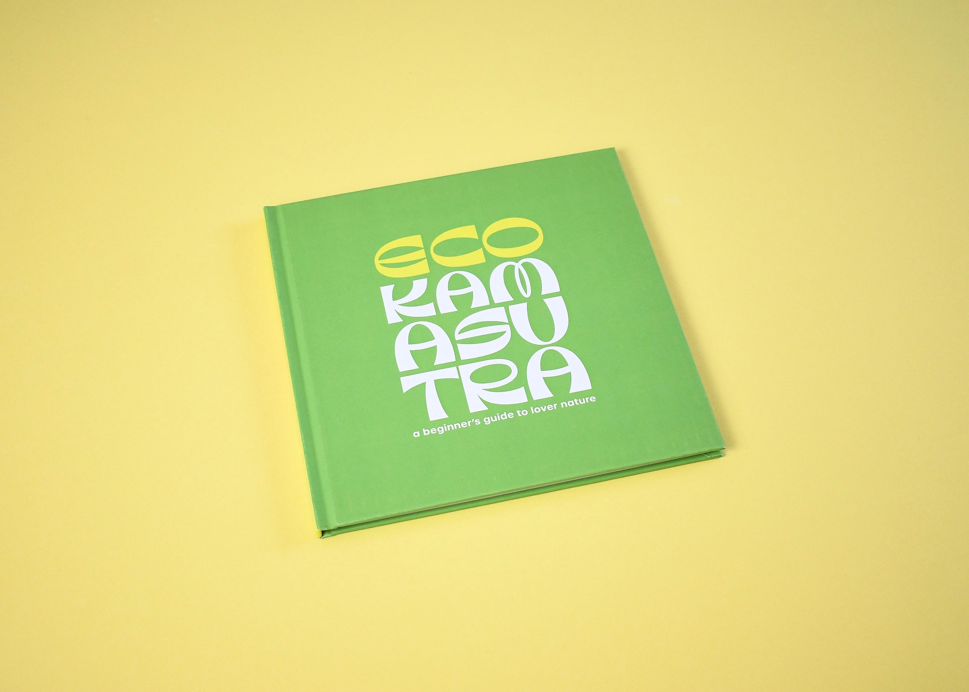 Eco Kamasutra, a square casebound hardback printed white and yellow on a green cover.