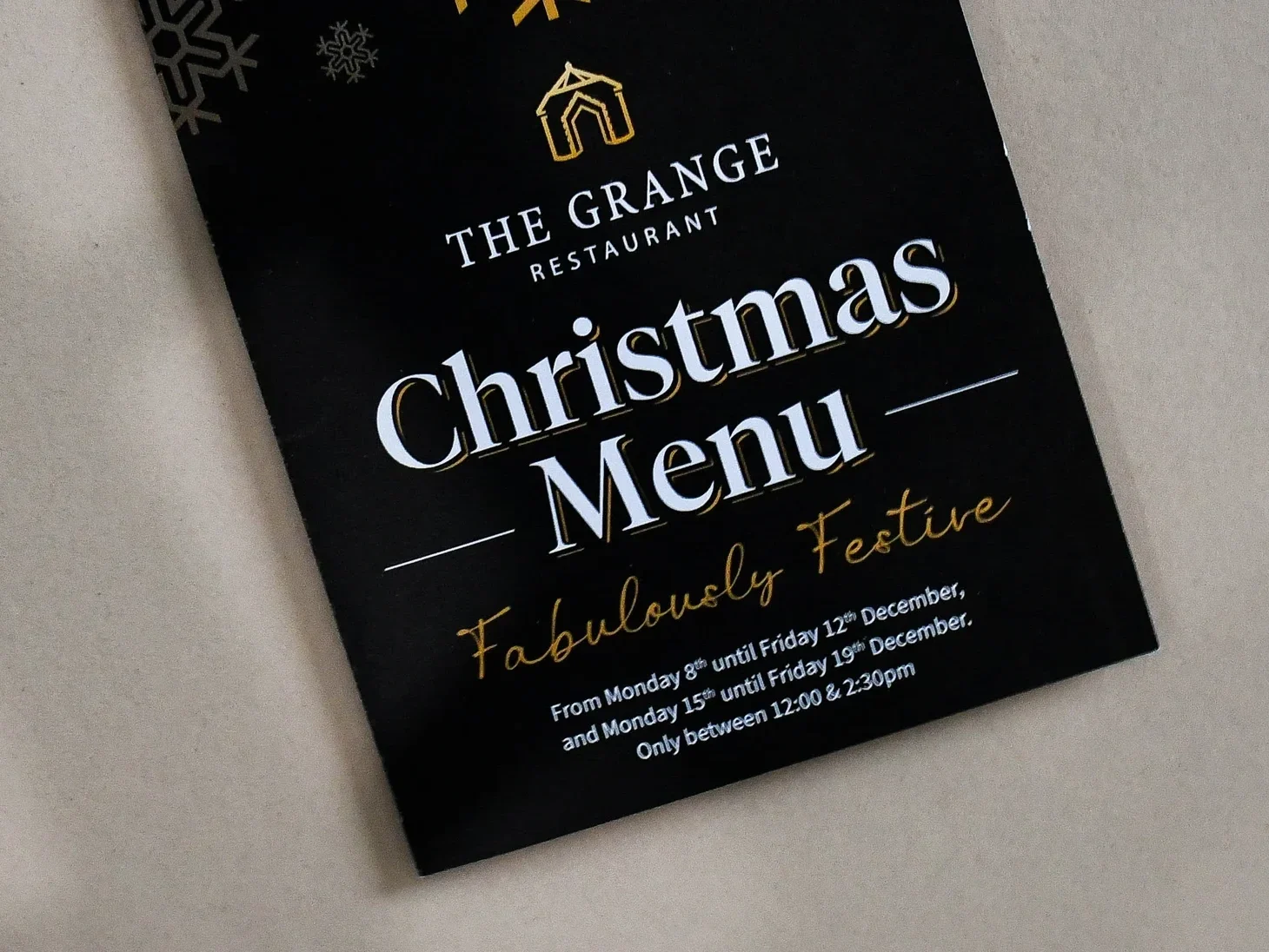 Christmas menu cover for The Grange Restaurant, printed gold and white on black.