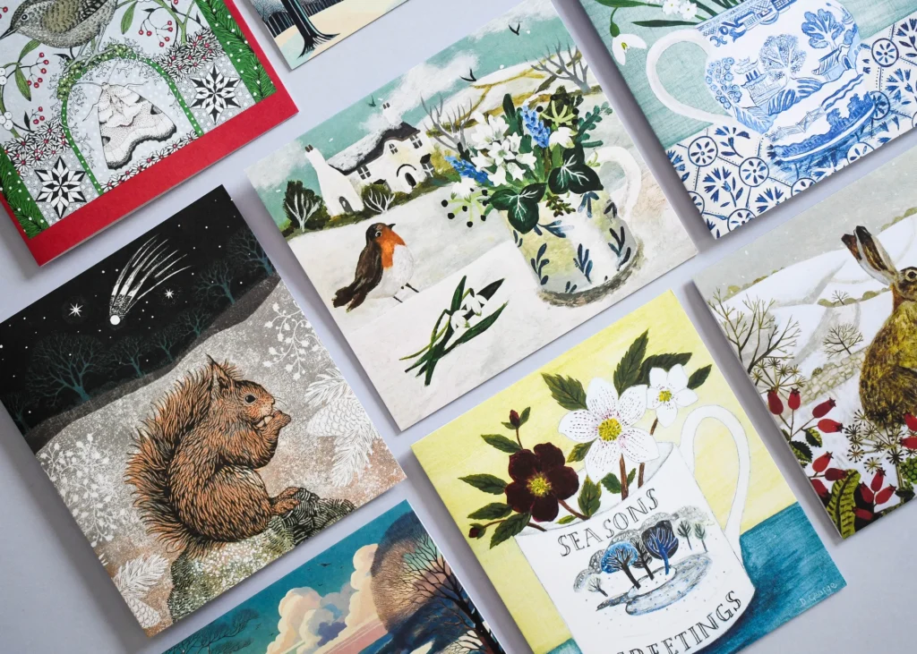 Illustrated Christmas cards showing a wren, red squirrel, robin, hare and winter flowers.