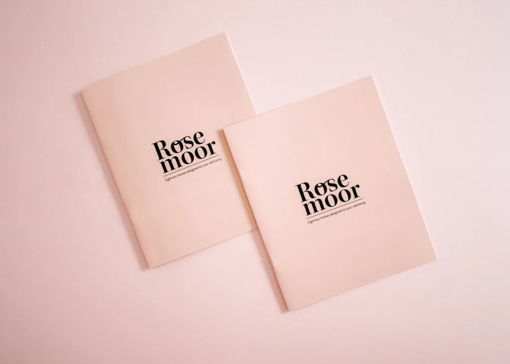 Two Rosemoor brochure covers on pale pink uncoated stock, saddle stitched, with the logo in black.