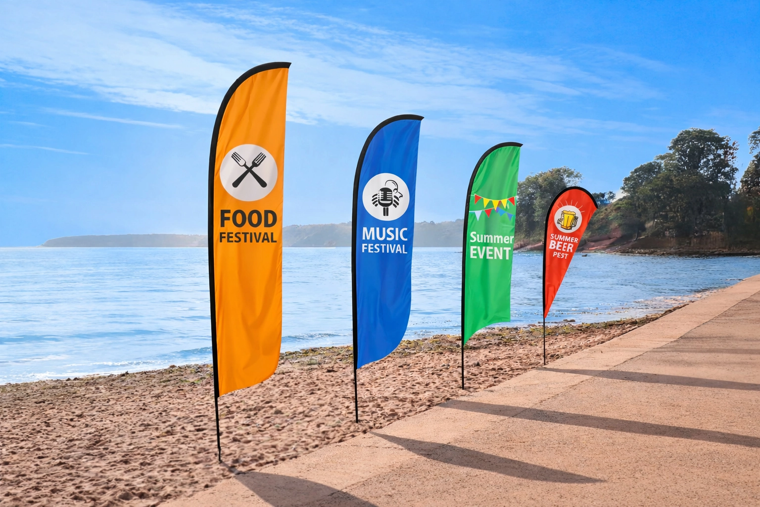 Row of multi coloured large format flags on a sunny beach.