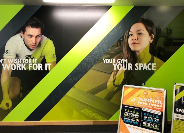 Large printed wall graphic in a gym.