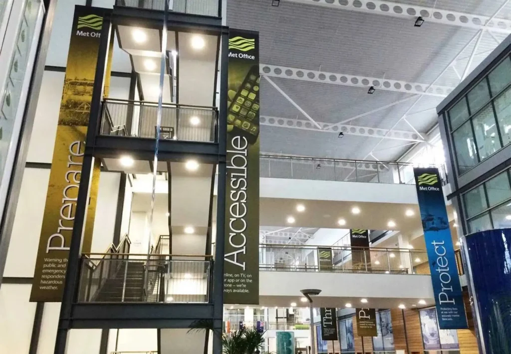 Large banners applied to a spacious entranceway, creating a welcoming and impactful visual display for visitors.