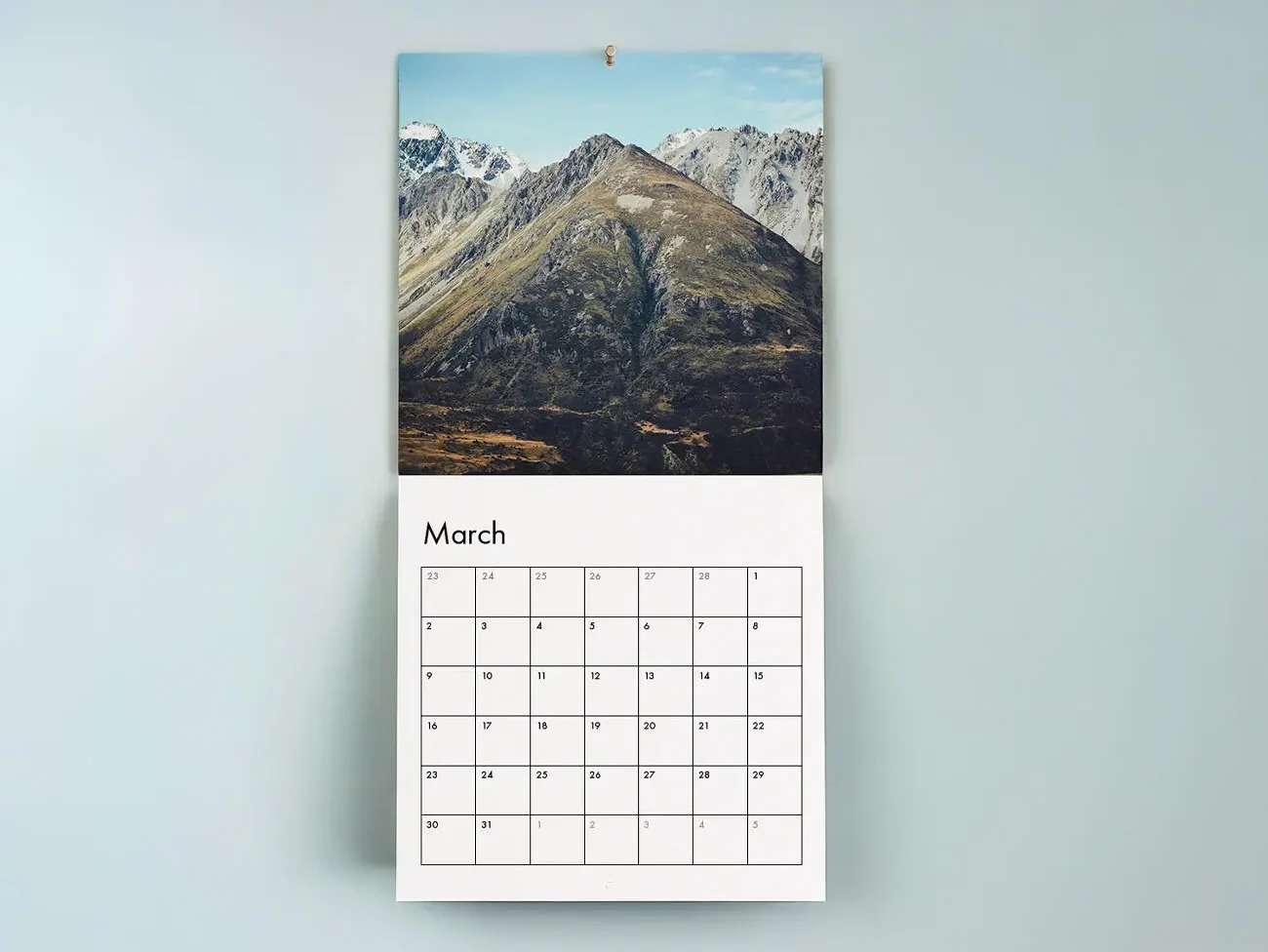 Custom printed wall calendar featuring a landscape photograph and monthly calendar layout.