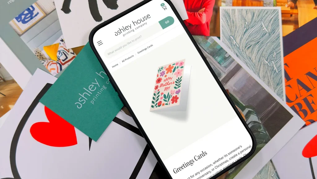 A phone with our new online shop loaded onto it showing greetings cards.