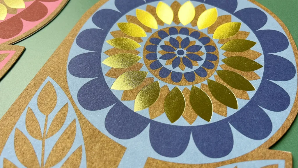 A beautiful greetings card design of a flower with foil detail.