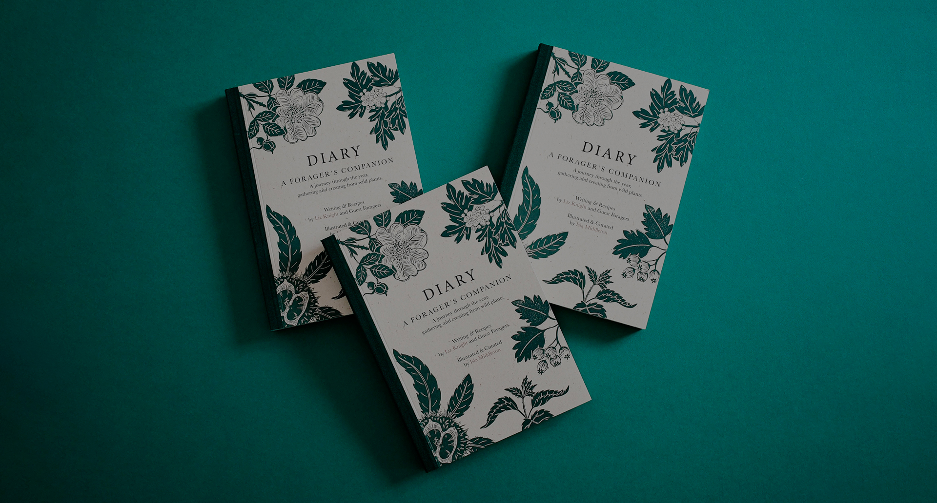 Three diaries with Linocut illustrations of flowers and plants.