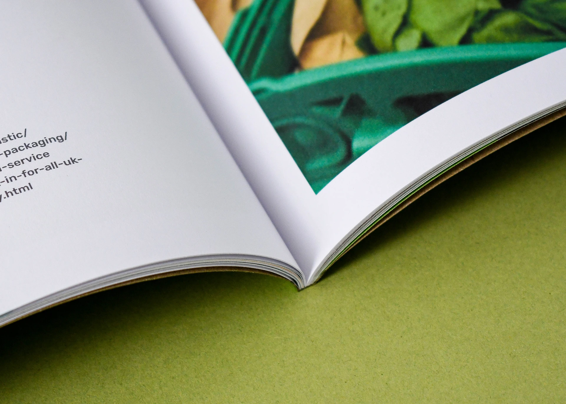 Close-up of an open magazine showing premium paper stock, clean page edges and professional magazine binding