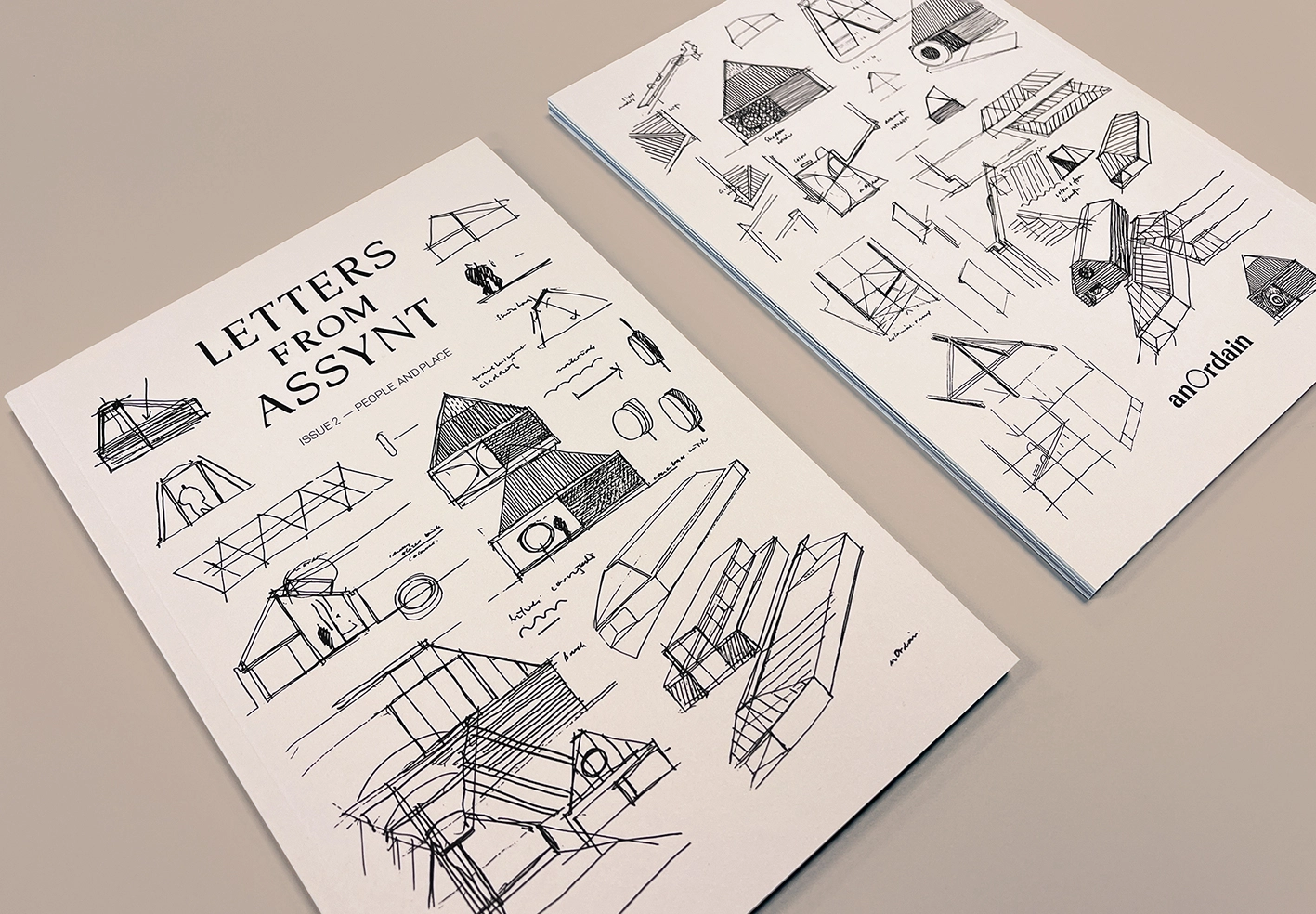 Two printed magazine covers featuring black architectural sketches and minimalist editorial design
