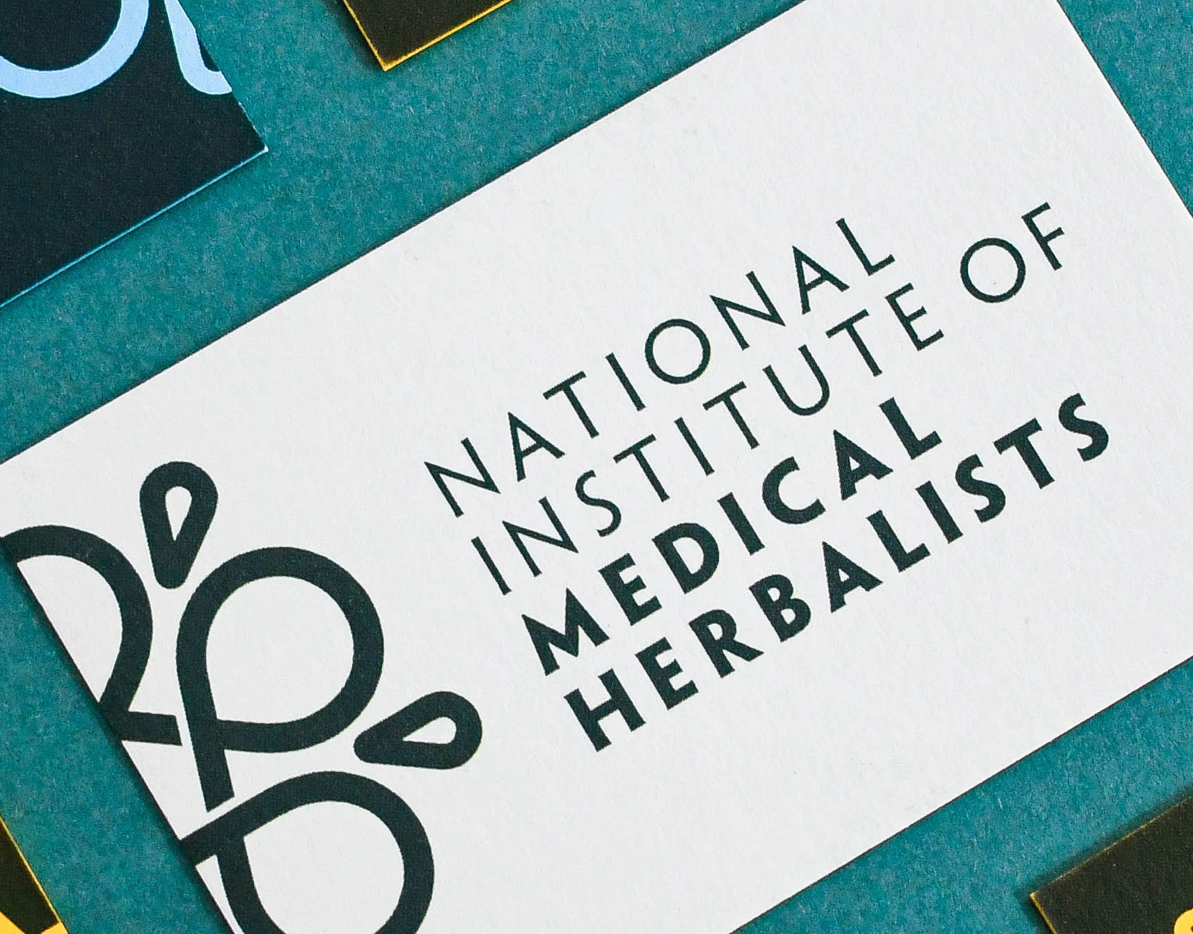 Business card for the National Institute of Medical Herbalists, with debossed lettering and a leaf emblem.