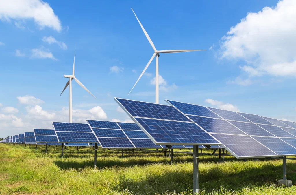Solar panels and wind turbines generating renewable energy for sustainable manufacturing