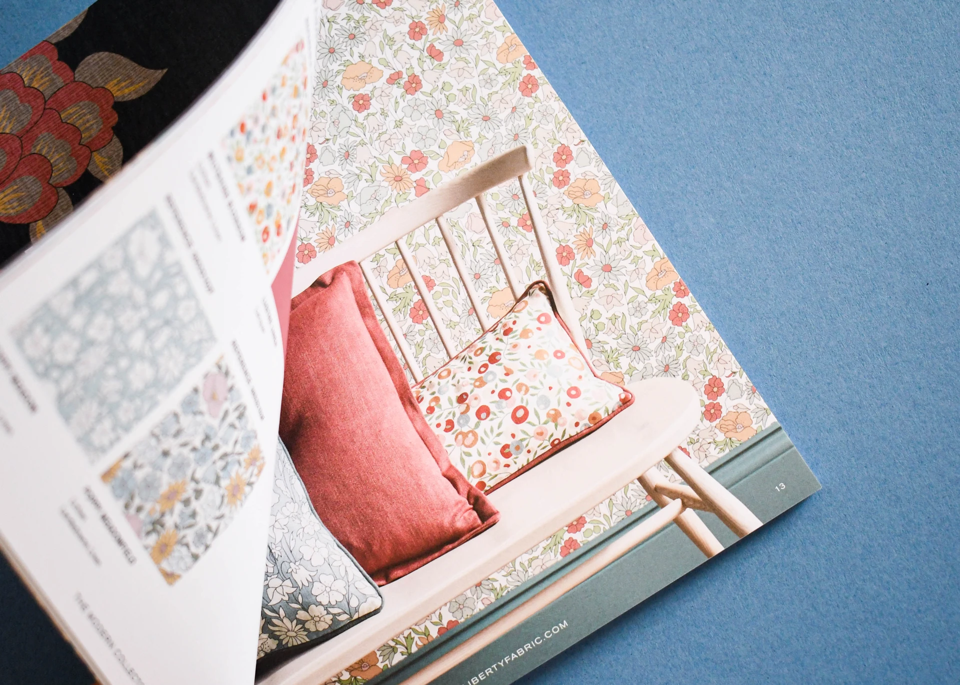 Catalogue spread with a full page interiors photograph facing a grid of pattern swatches.