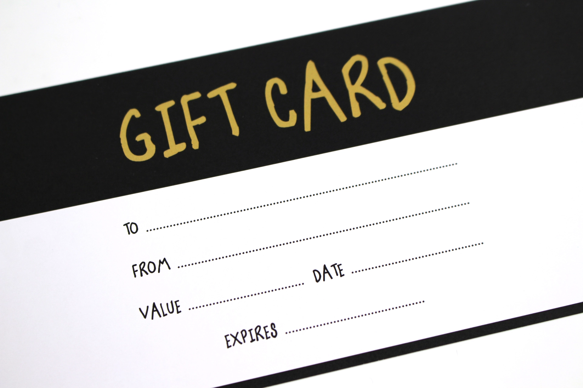 Printed gift card with a gold heading and blank lines for name, date and value.