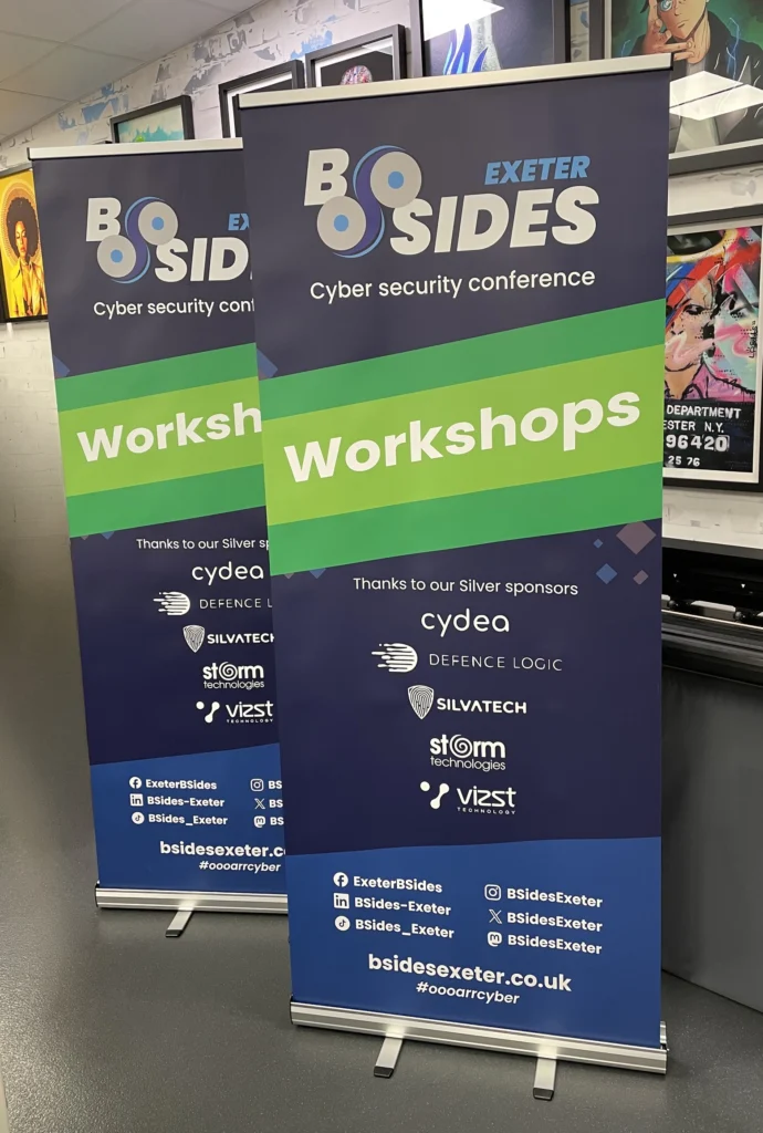 Two pull-up banners standing side by side, printed for a conference.