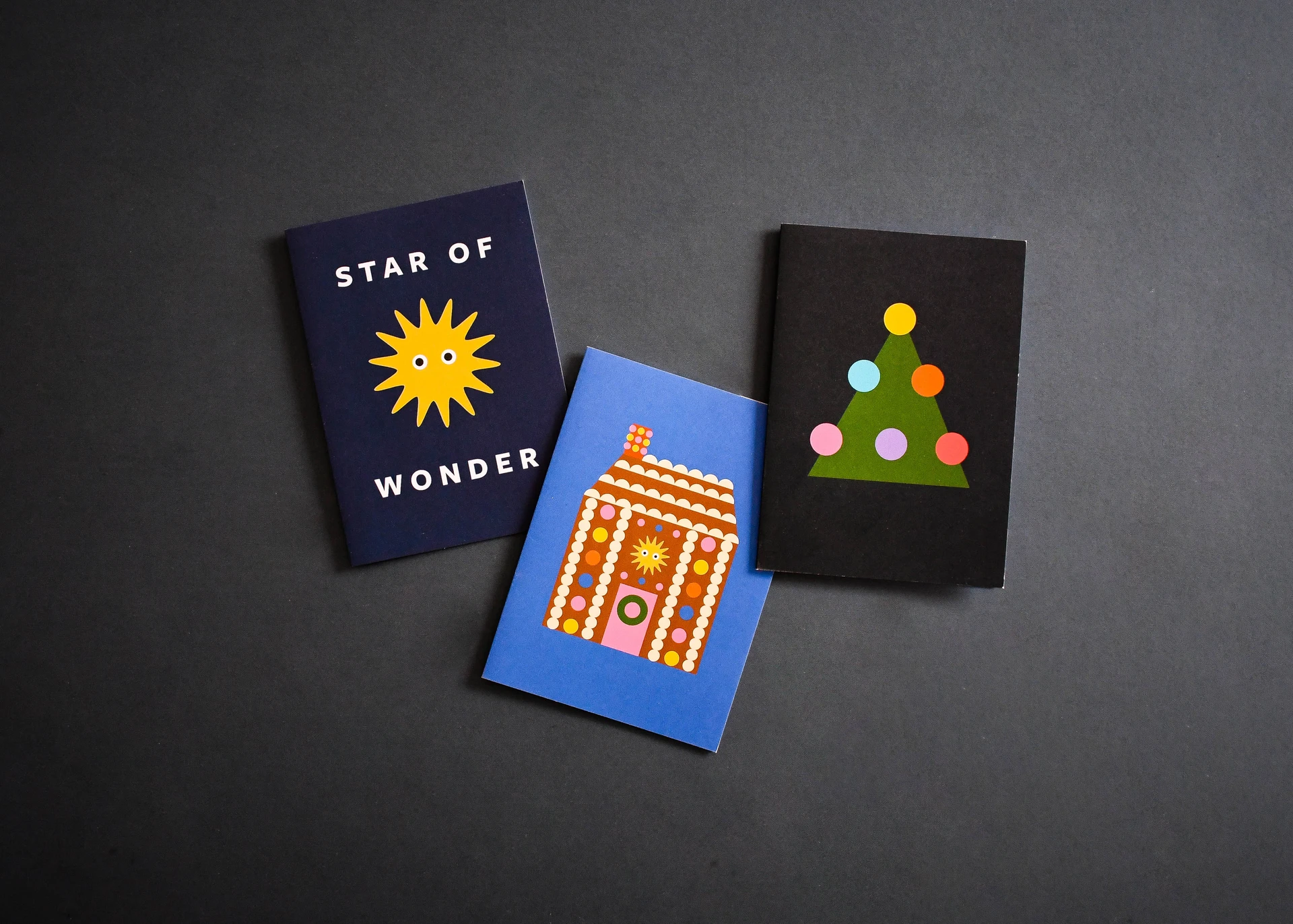 Three flat-colour Christmas cards: Star of Wonder, a gingerbread house and a dotted tree.