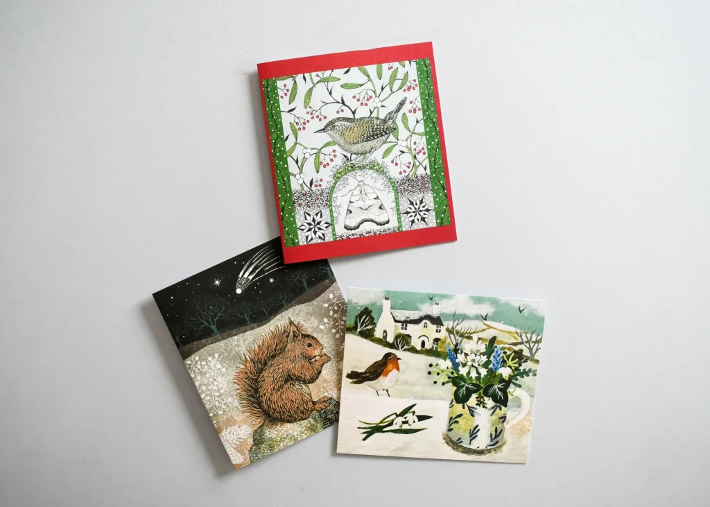 Three illustrated Christmas cards showing a wren, a red squirrel and a robin.